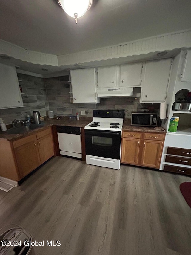 kitchen with white appliances, sink, decorative backsplash, light wood-type flooring, and white cabinetry