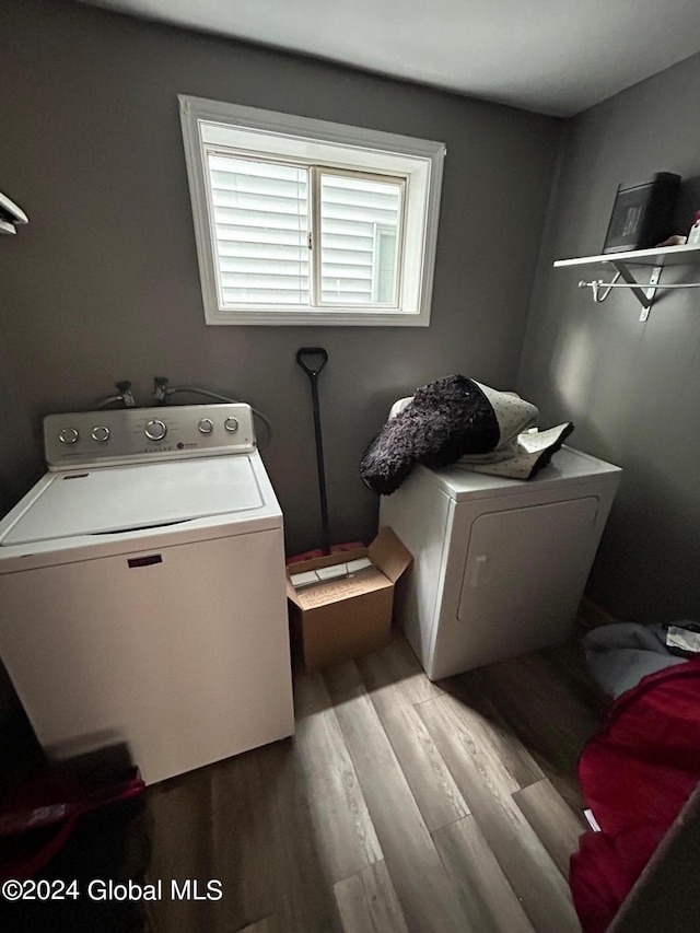 laundry room with washer / clothes dryer and light hardwood / wood-style floors