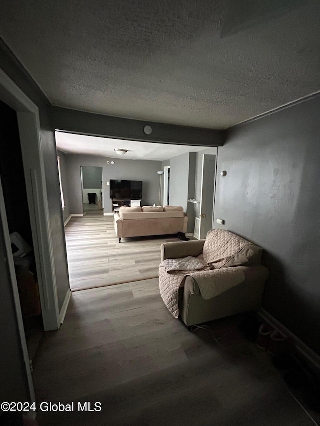 interior space featuring light hardwood / wood-style floors and a textured ceiling