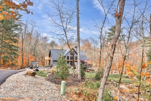 rear view of property featuring a wooden deck