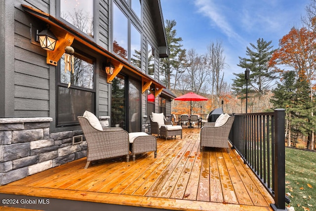 wooden deck with an outdoor living space