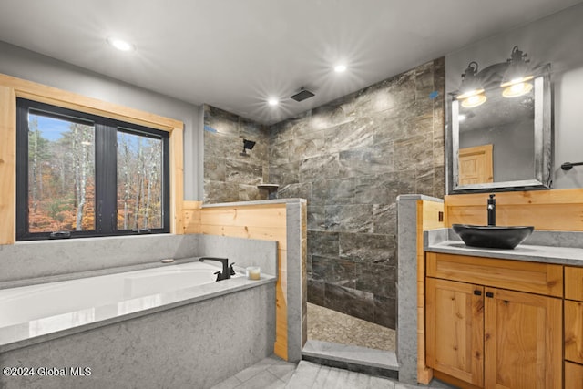 bathroom with vanity, tile walls, and plus walk in shower