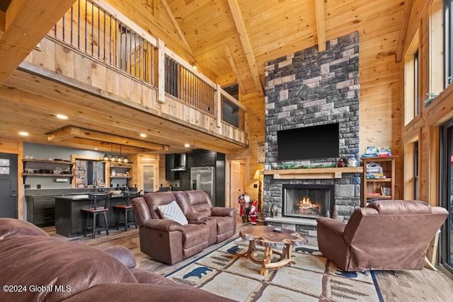 living room featuring beamed ceiling, high vaulted ceiling, and wood-type flooring