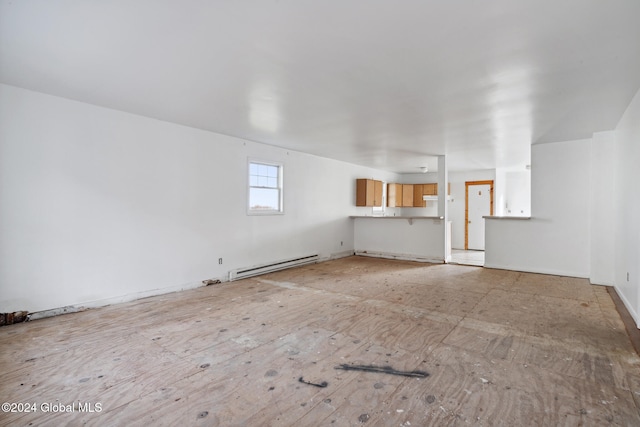 unfurnished living room featuring a baseboard heating unit