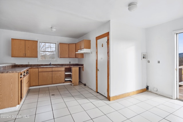 kitchen featuring sink and light tile patterned floors