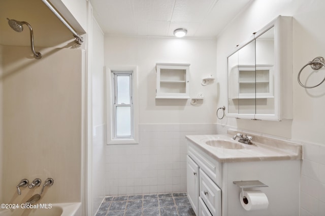 bathroom featuring vanity, shower / tub combination, tile walls, and tile patterned flooring