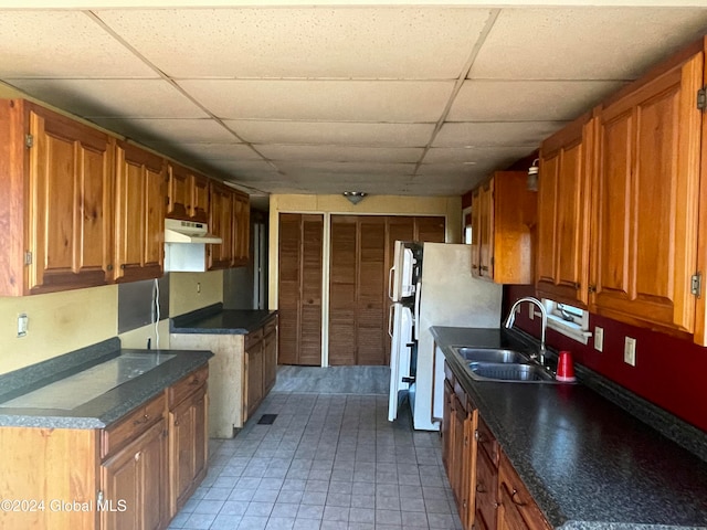 kitchen featuring a paneled ceiling and sink