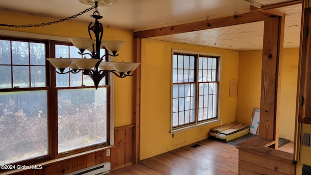 interior space featuring a baseboard radiator, hardwood / wood-style floors, and a wealth of natural light