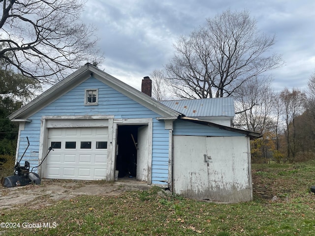 exterior space featuring an outbuilding and a garage