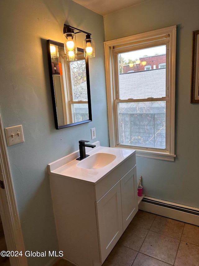 bathroom featuring baseboard heating, tile patterned flooring, and vanity