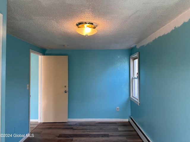 unfurnished room featuring a textured ceiling, a baseboard radiator, and dark hardwood / wood-style floors