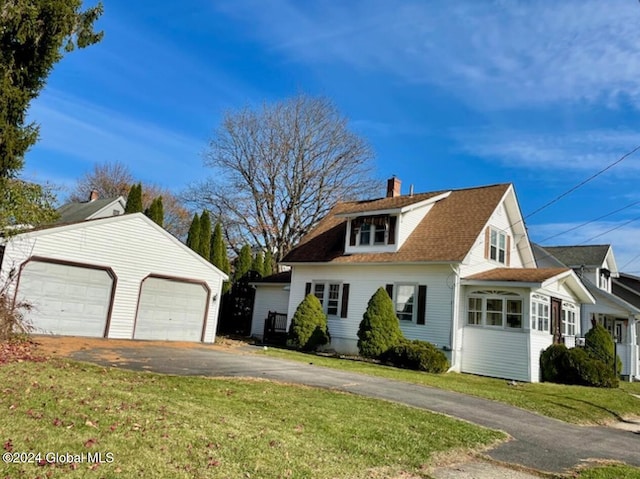 view of side of property with a lawn and a garage