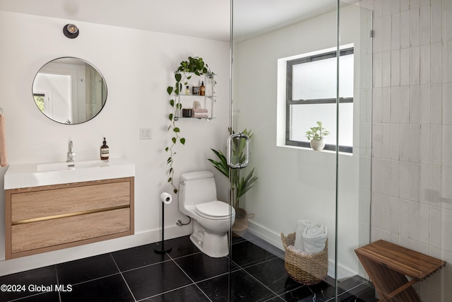 bathroom featuring tile patterned flooring, vanity, toilet, and a shower