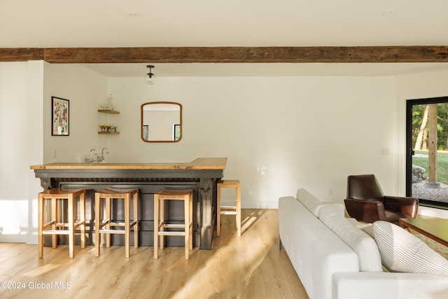 interior space featuring light hardwood / wood-style floors and beamed ceiling