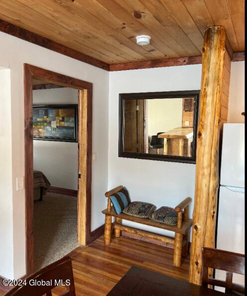 corridor featuring hardwood / wood-style flooring and wooden ceiling