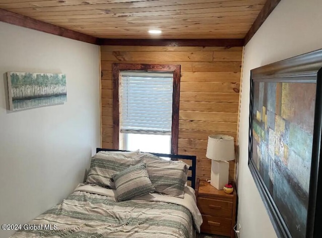 bedroom with wood walls and wood ceiling