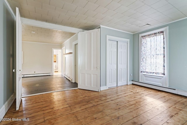 interior space featuring crown molding, light hardwood / wood-style flooring, and a baseboard radiator