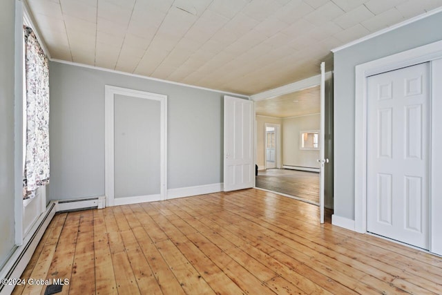 unfurnished bedroom with a baseboard heating unit, ornamental molding, and light hardwood / wood-style flooring