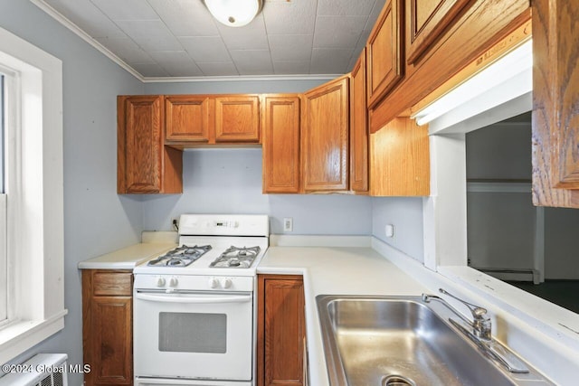 kitchen with sink, white range with gas stovetop, and ornamental molding