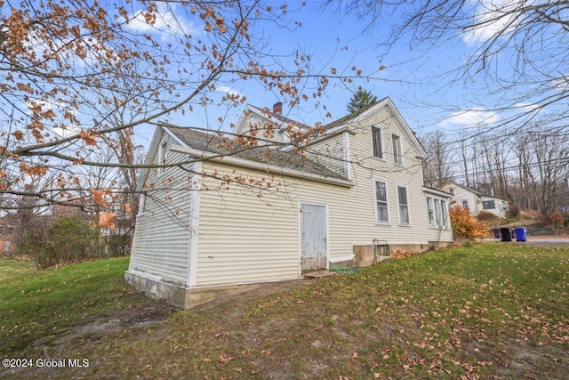 view of property exterior with a lawn