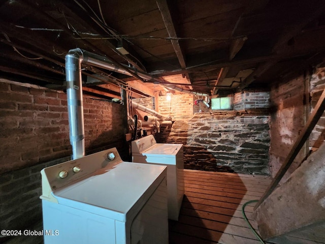 basement with washer and dryer and hardwood / wood-style flooring