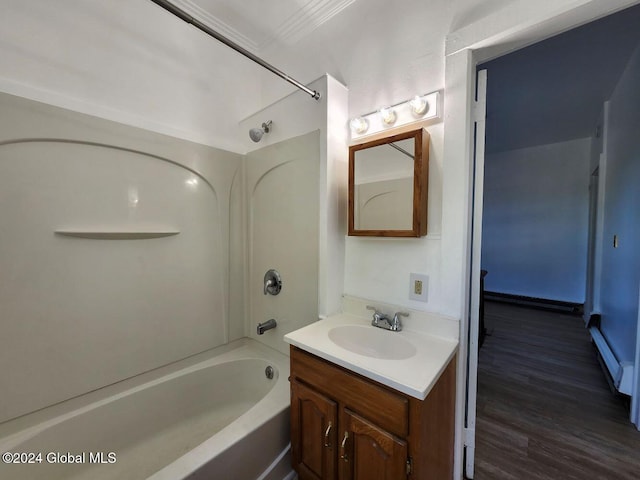 bathroom featuring hardwood / wood-style flooring, vanity, shower / bathtub combination, and baseboard heating