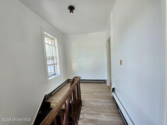 hall featuring light hardwood / wood-style floors and a baseboard heating unit