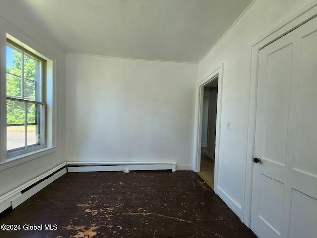 unfurnished room with a baseboard heating unit