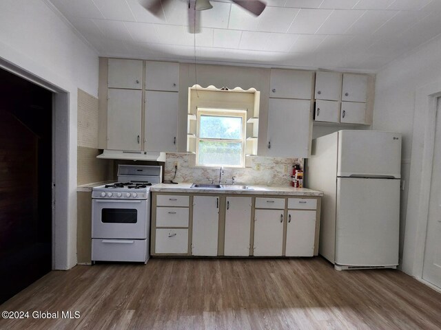 kitchen featuring white cabinetry, sink, white appliances, and light wood-type flooring