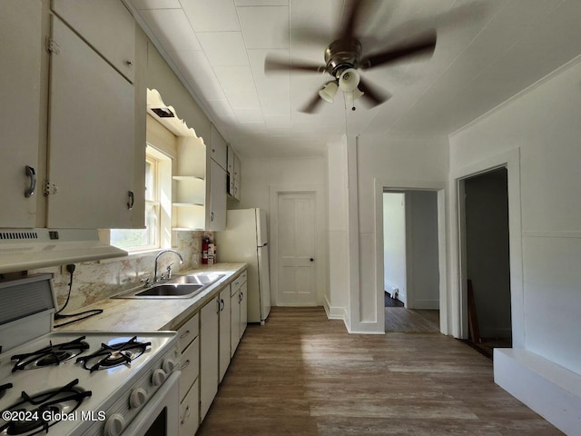 kitchen with white appliances, white cabinets, sink, wood-type flooring, and extractor fan