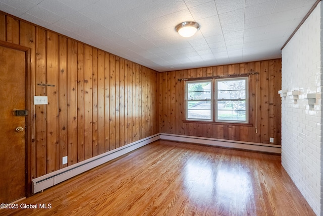 1258 Hawthorn Rd, Niskayuna, NY 12309 - unfurnished room with wood finished floors, a baseboard heating unit, wood walls, and baseboards