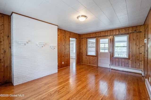 1258 Hawthorn Rd, Niskayuna, NY 12309 - empty room featuring a baseboard radiator, light wood-style floors, and wood walls