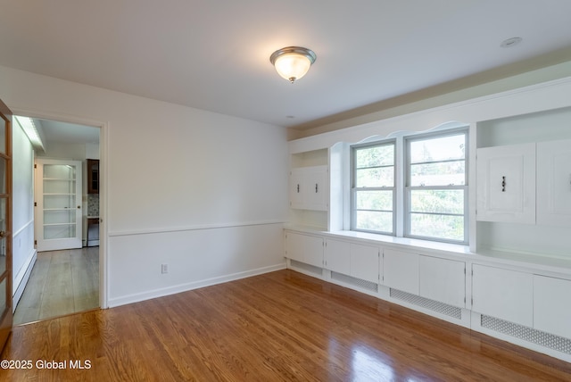 1258 Hawthorn Rd, Niskayuna, NY 12309 - spare room with wood finished floors, baseboard heating, and baseboards