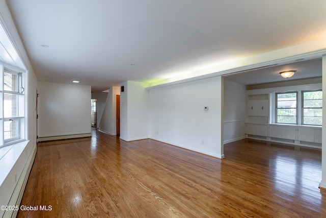1258 Hawthorn Rd, Niskayuna, NY 12309 - spare room featuring baseboard heating, a baseboard heating unit, wood finished floors, and baseboards
