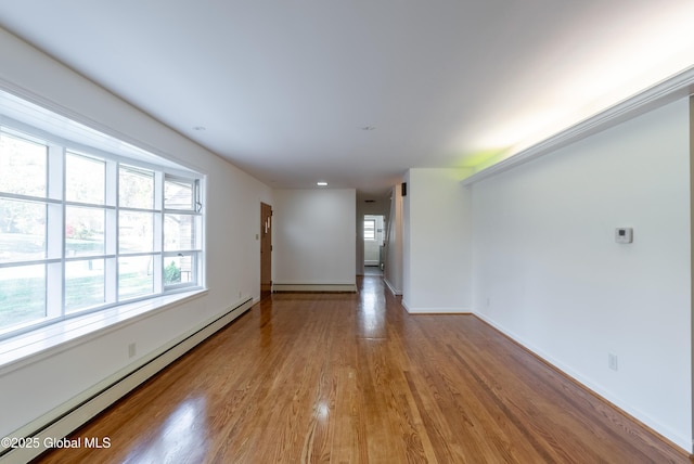 1258 Hawthorn Rd, Niskayuna, NY 12309 - unfurnished room with baseboard heating, plenty of natural light, wood finished floors, and baseboards