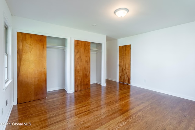 1258 Hawthorn Rd, Niskayuna, NY 12309 - unfurnished bedroom featuring wood finished floors, two closets, and baseboards