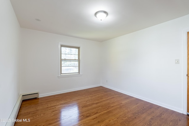 1258 Hawthorn Rd, Niskayuna, NY 12309 - unfurnished room featuring wood finished floors, a baseboard heating unit, and baseboards