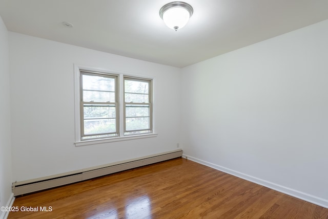 1258 Hawthorn Rd, Niskayuna, NY 12309 - unfurnished room featuring a baseboard heating unit, wood finished floors, and baseboards