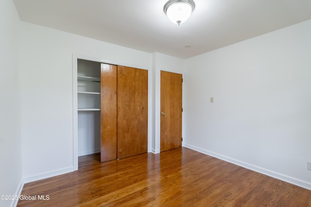 1258 Hawthorn Rd, Niskayuna, NY 12309 - unfurnished bedroom featuring wood finished floors, a closet, and baseboards