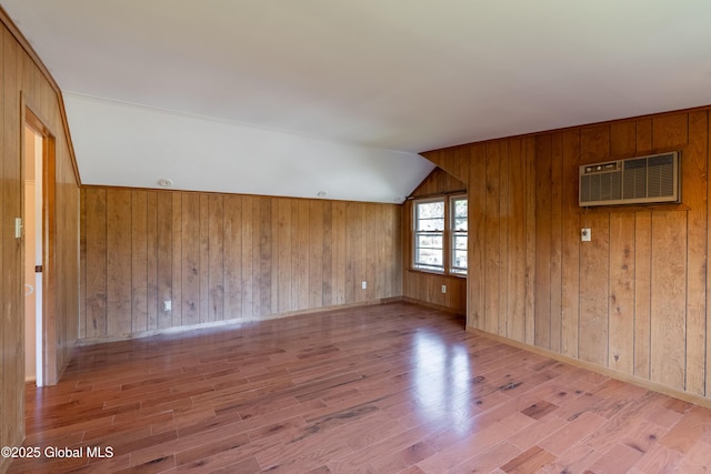 1258 Hawthorn Rd, Niskayuna, NY 12309 - unfurnished room featuring an AC wall unit, wood finished floors, vaulted ceiling, and wooden walls