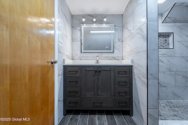 1258 Hawthorn Rd, Niskayuna, NY 12309 - bathroom featuring vanity, a tile shower, tile walls, and wood finish floors