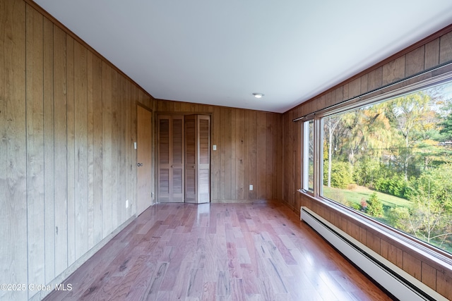 1258 Hawthorn Rd, Niskayuna, NY 12309 - empty room featuring a baseboard radiator, wooden walls, and light wood finished floors