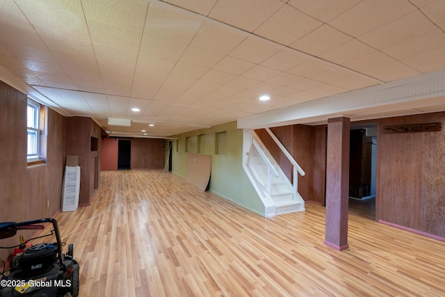 1258 Hawthorn Rd, Niskayuna, NY 12309 - below grade area with wooden walls, light wood-style flooring, and stairway