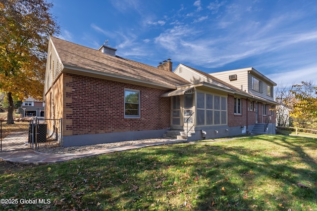 1258 Hawthorn Rd, Niskayuna, NY 12309 - rear view of house with brick siding, a sunroom, a gate, a chimney, and entry steps