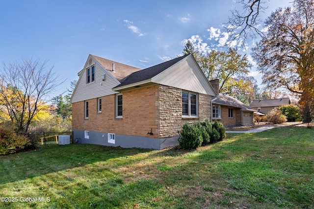 1258 Hawthorn Rd, Niskayuna, NY 12309 - view of side of home featuring cooling unit, a lawn, an attached garage, and a chimney