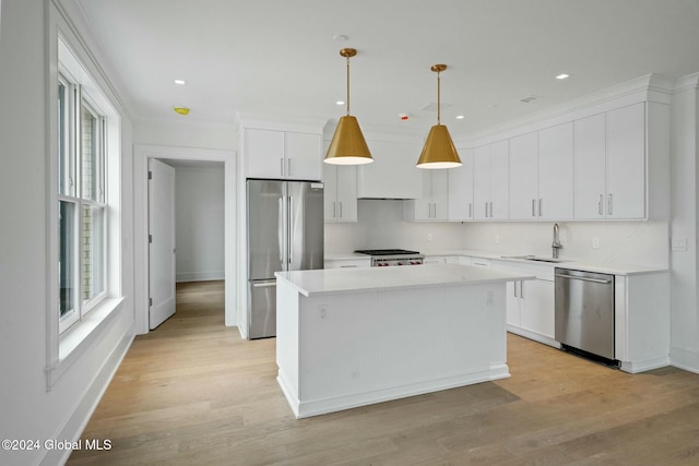 kitchen featuring a sink, a center island, white cabinetry, and stainless steel appliances