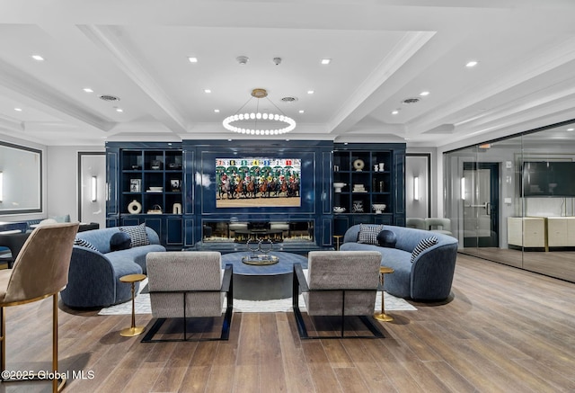 living area with built in features, visible vents, indoor bar, and wood finished floors