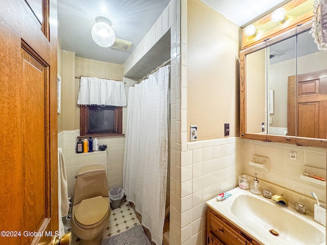 bathroom featuring a shower with shower curtain, toilet, and tile walls