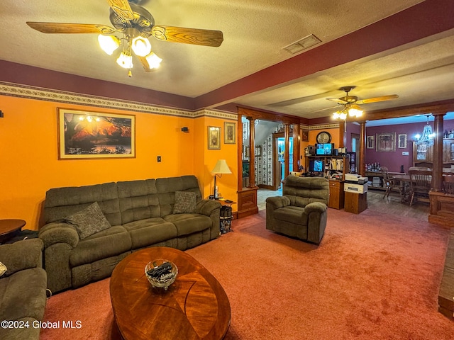 carpeted living room with ceiling fan, a textured ceiling, and decorative columns