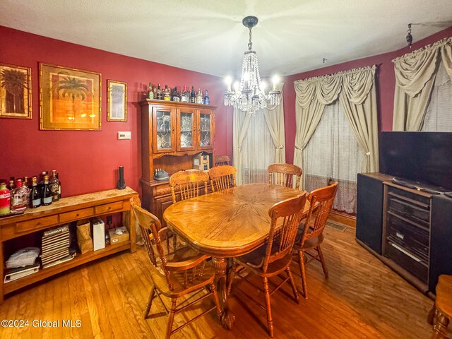 dining room with a chandelier and wood-type flooring